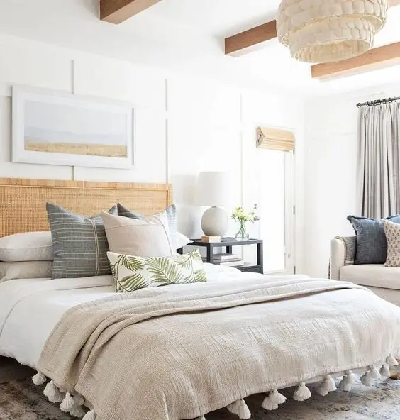 Bright Nature coastal bedroom: A shell chandelier, a woven rattan headboard and sandy neutrals with green and timber worked
