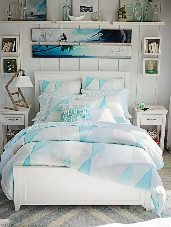Teen Surfer coastal bedroom: Blue and white bedding, glass jars, a surf print and a striped rug. It's a teen room that will