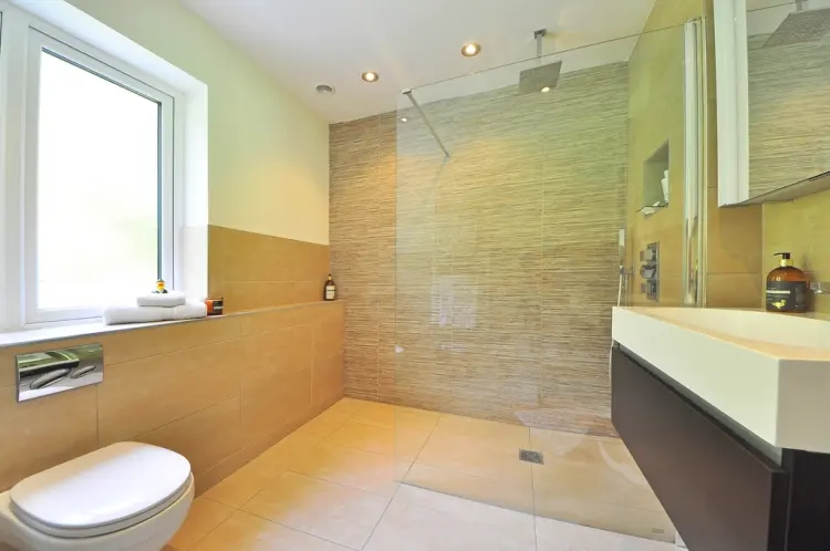 Bathroom with a walk-in shower, timber vanity and pale tiles