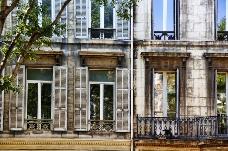 Shuttered windows on an old rendered wall